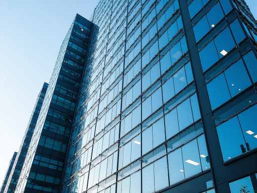 Modern office building exterior with glass facade, professional business environment, blue sky background, high resolution photography